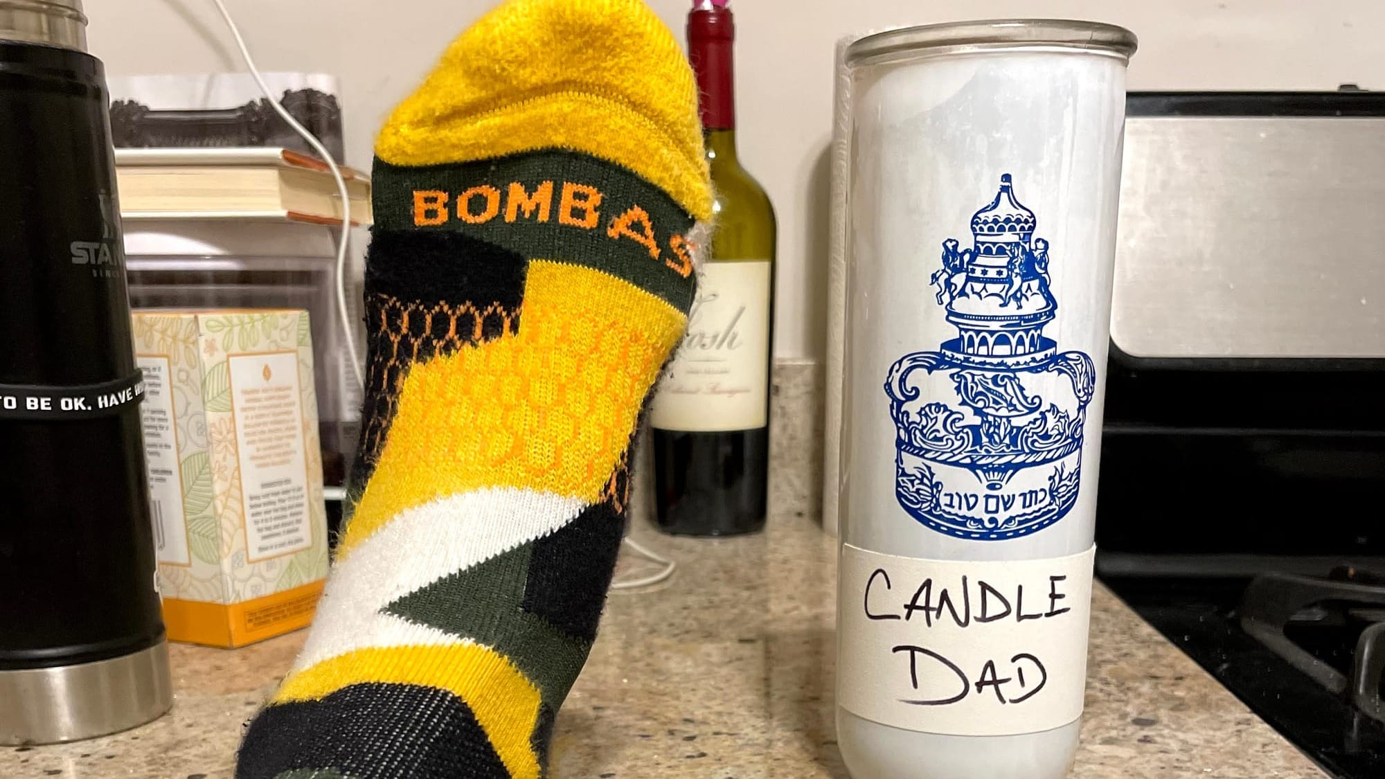 A sock and candle holder on a countertop.