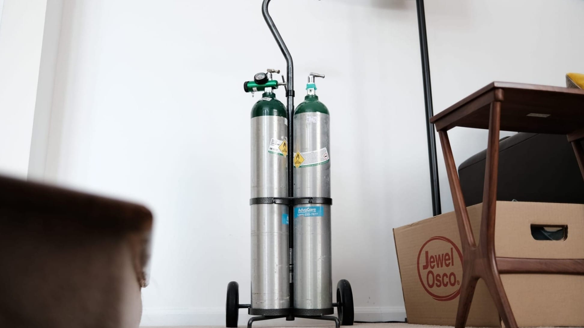 Oxygen tanks against a white wall.